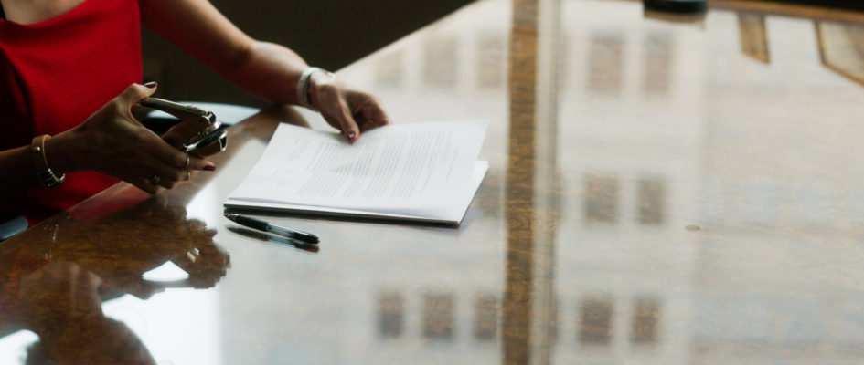 Attorney organizing documents on a desk